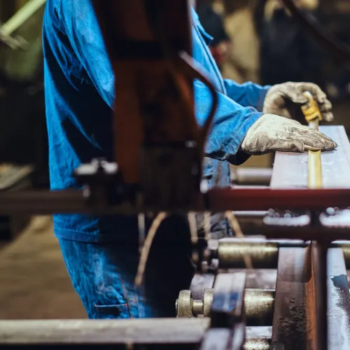 a man measuring a metal plate